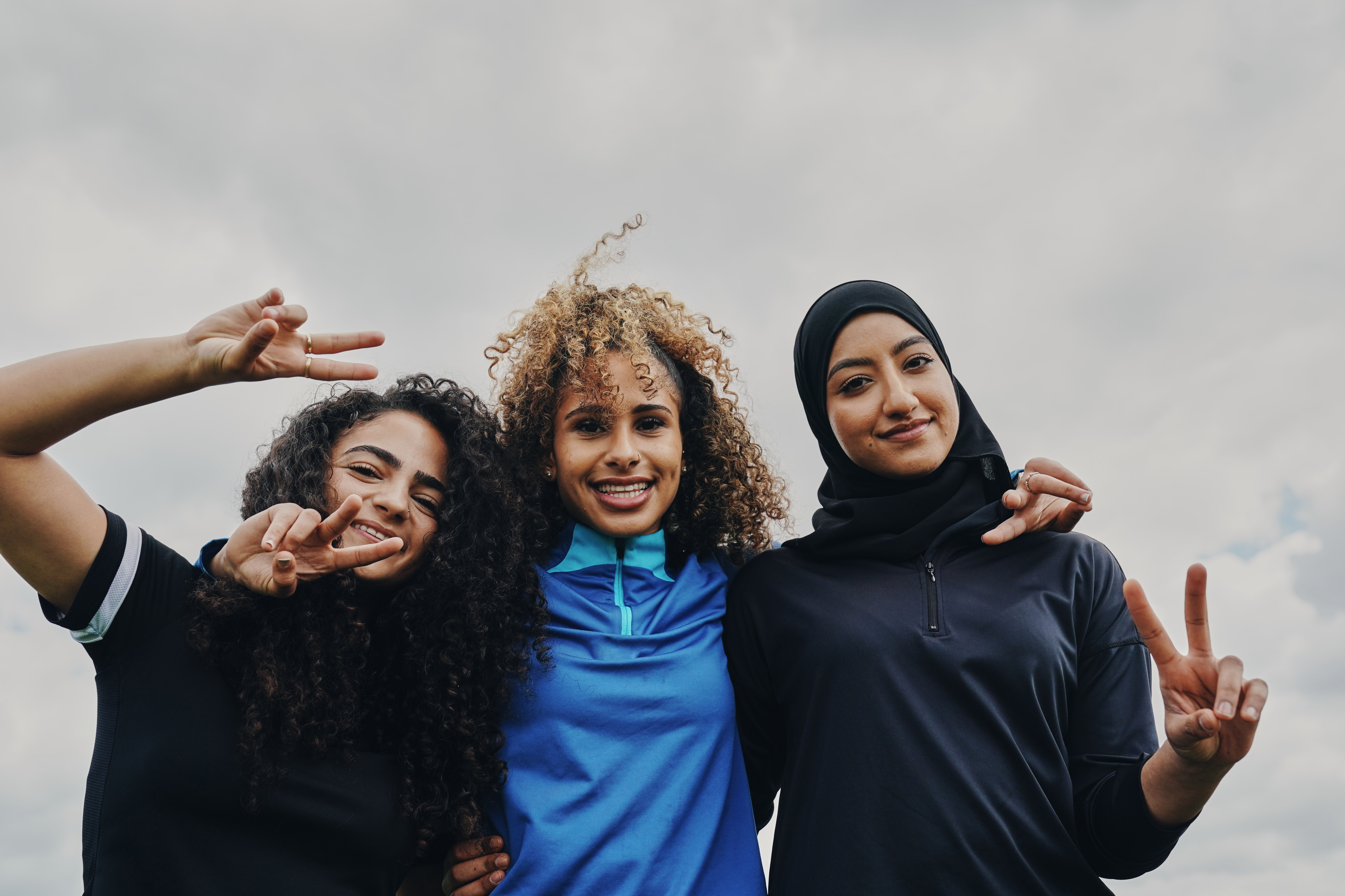 three women smiling at camera 